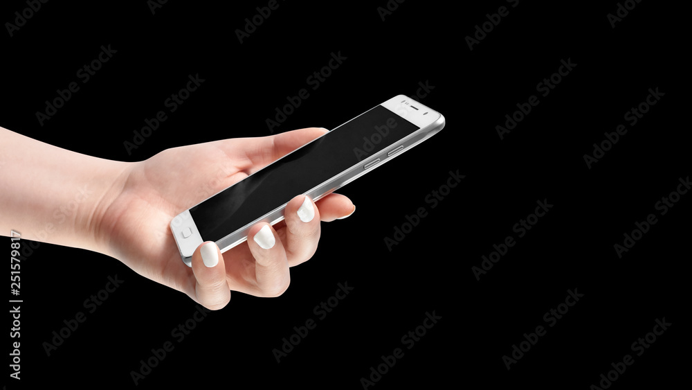 Female hand holding modern smartphone on dark black background Female hand holding modern smartphone on dark black background