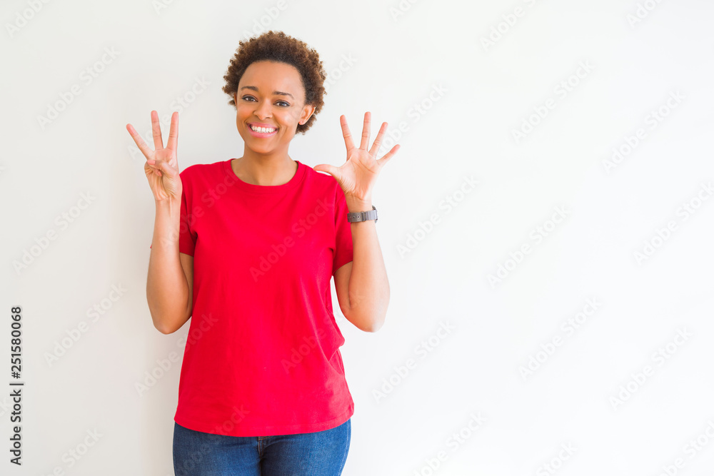 Young beautiful african american woman over white background showing and pointing up with fingers number eight while smiling confident and happy. Young beautiful african american woman over white background showing and pointing up with fingers number eight while smiling confident and happy.