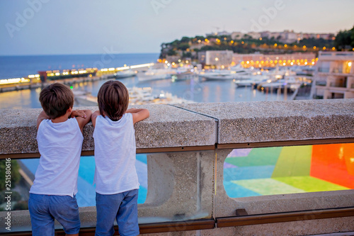 Two boys enjoying the city of Monaco in the evening, having fun