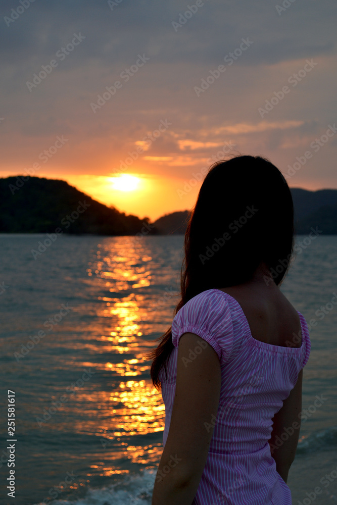 young woman at sunset