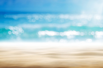 Blur tropical beach with bokeh sun light wave abstract background.