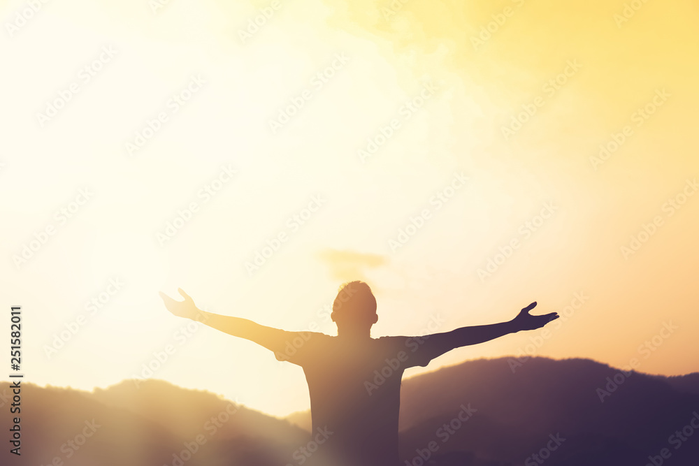 Copy space of man rise hand up on top of mountain and sunset sky abstract background. Copy space of man rise hand up on top of mountain and sunset sky abstract background.