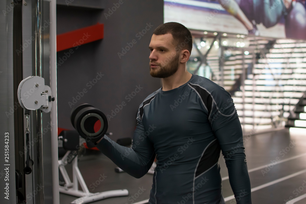 Man in the gym with kettlebells and weights. Man in the gym with kettlebells and weights.