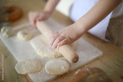 in the kitchen the baby rolls and plays with the dough and make pizza and bread