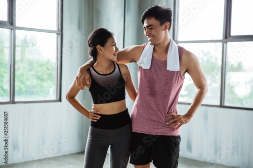 asian couple sport laughing during exercise break indoor together © Odua Images