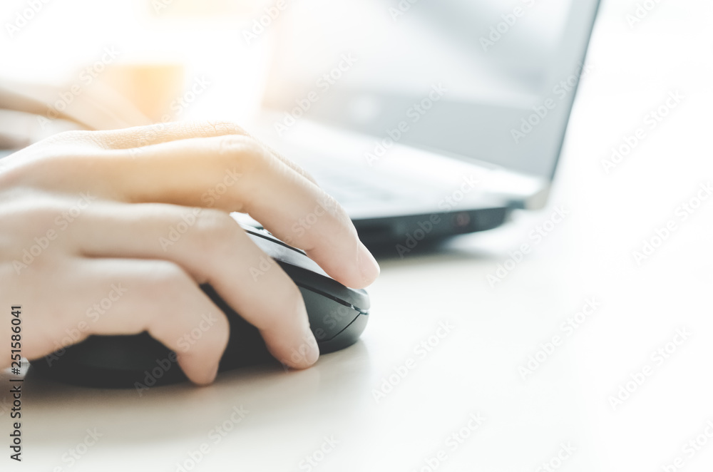 Fototapeta premium Close up woman hand using laptop on wood table.
