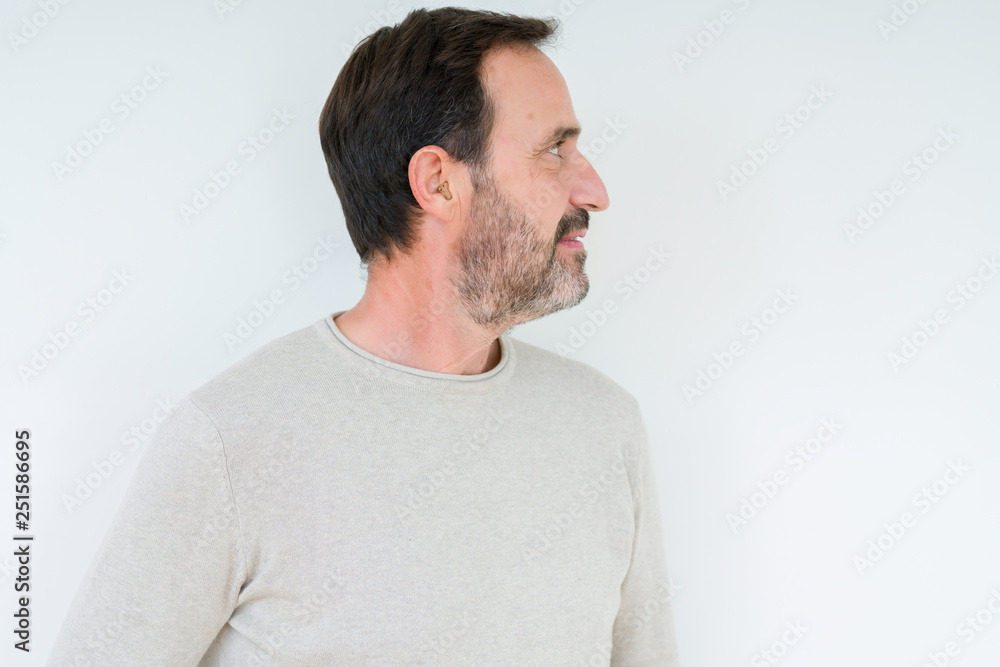 Elegant senior man over isolated background looking to side, relax profile pose with natural face with confident smile. Elegant senior man over isolated background looking to side, relax profile pose with natural face with confident smile.