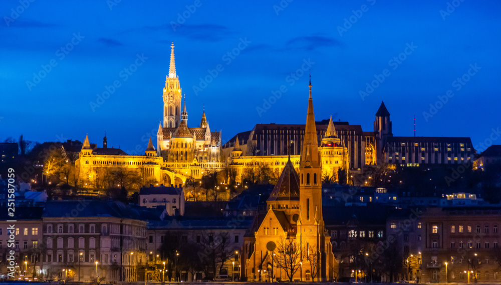 Fisherman's bastion in night lighting and its reflection in the Danube in Budapest, Hungary