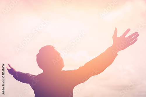  Copy space of happy man raise hands on sunset sky with sun light abstract background. © tonktiti