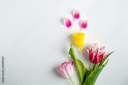 Fototapeta Naklejka Na Ścianę i Meble -  menstrual cup with flower tulip. concept on women alternative hygiene