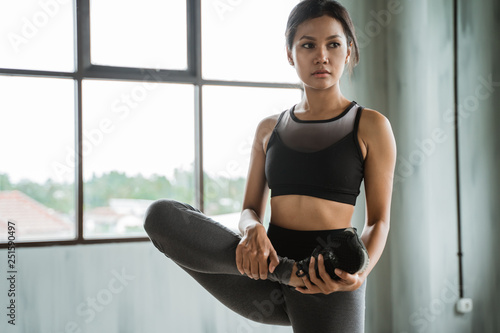 sport woman stretch her legs. warm up before exercise indoor Free Download sport woman stretch her legs. warm up before exercise indoor - GFXLoad