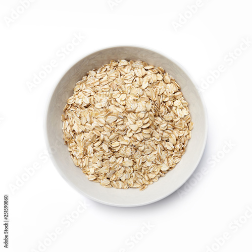 White bowl with oat-flakes cut out. Top view.