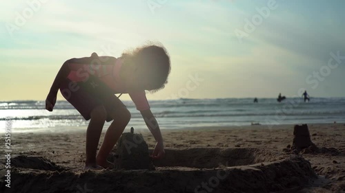 Young girl building sand castle on UK beach