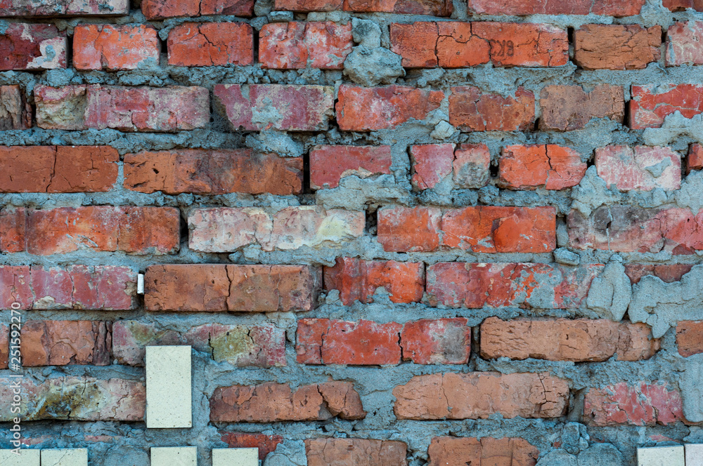 Obraz premium Background from old shabby bare bricks close up