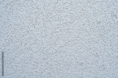 horizontal background of a wall with applied decorative gray uneven rough plaster