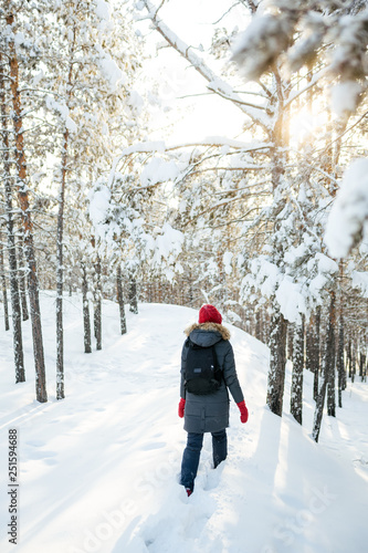 The girl in the red hat in the winter forest