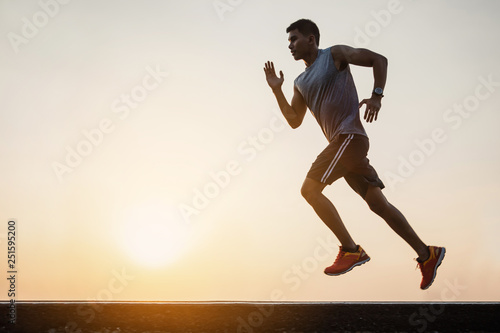 Young man running in the nature. Healthy lifestyle and sport concepts.  Runner training in a urban area.The man with runner on the street be running for exercise.