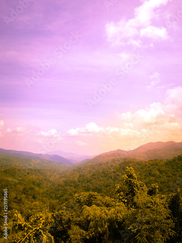 Travel and landscape in summer concept from panorama view of tropical forest with layer of mountain and cloudy background © tickcharoen04