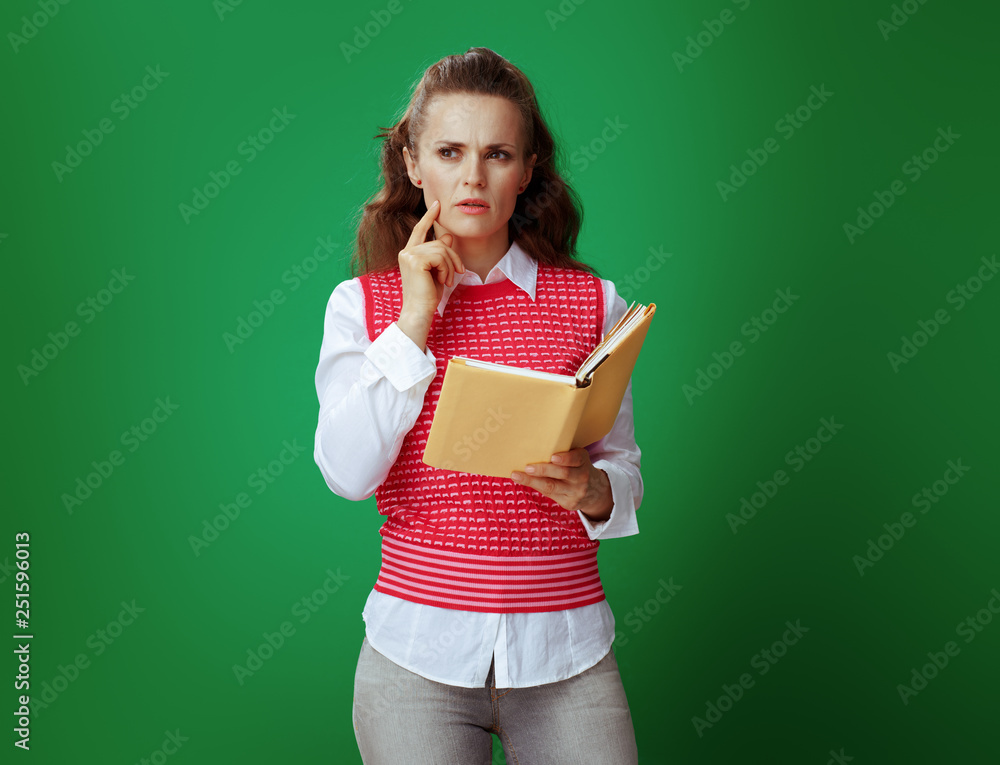 student woman with yellow book on chalkboard green background student woman with yellow book on chalkboard green background