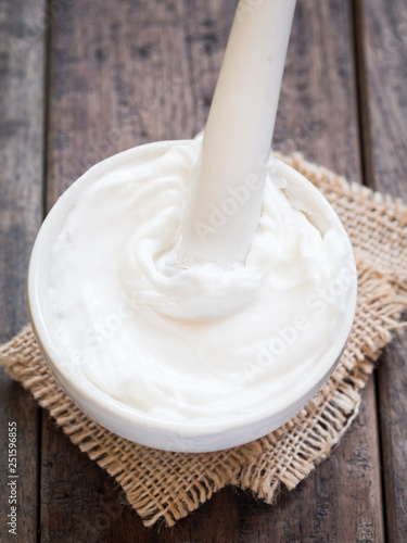 Homemade natural organic body butter in a mortar with pestle.