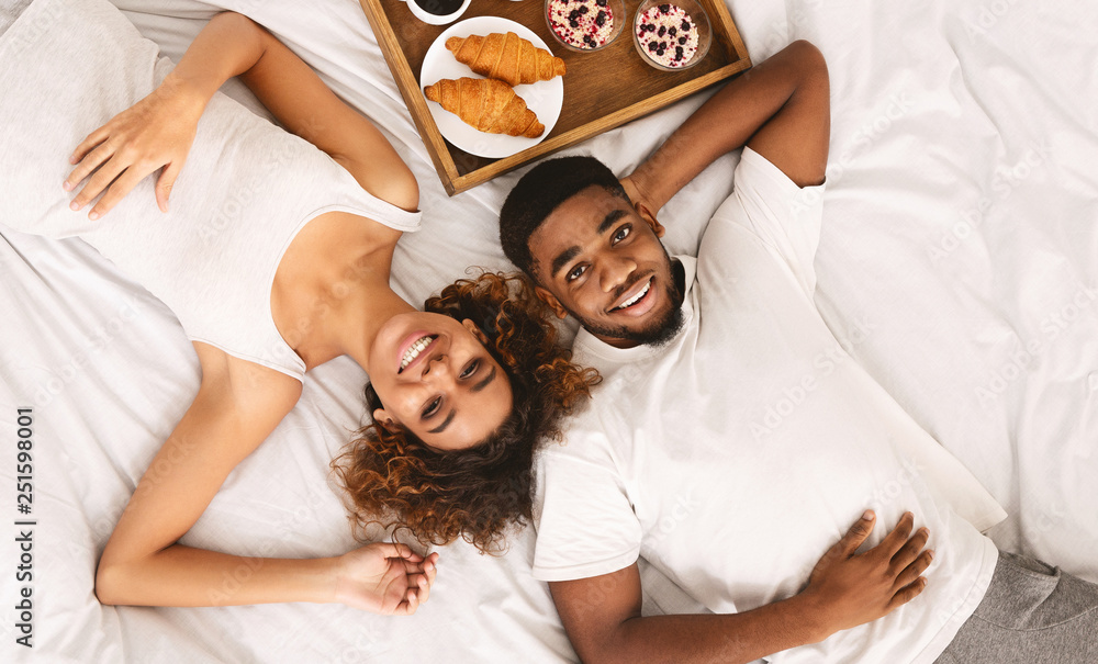 African-american couple enjoying healthy breakfast in bed