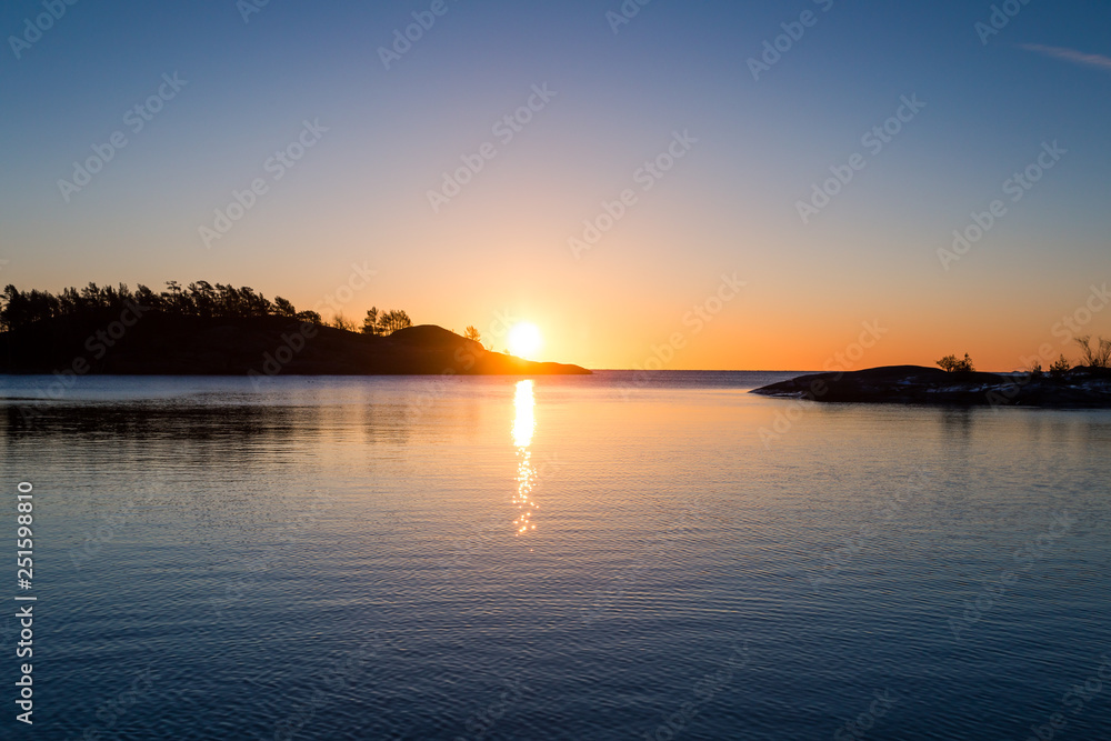 sunrise over tranquil water with reflection