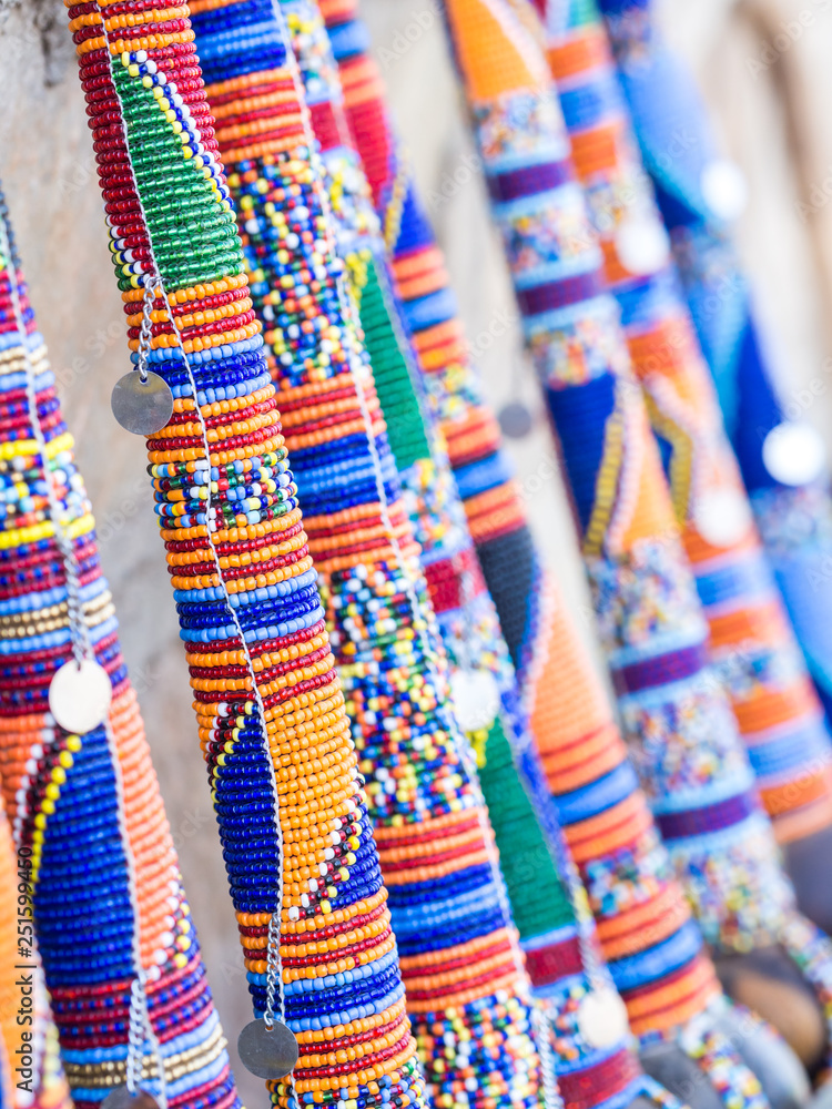Maasai rungu (club) decorated with beads and sold as a souvenir at a local Maasai Market. Close up.