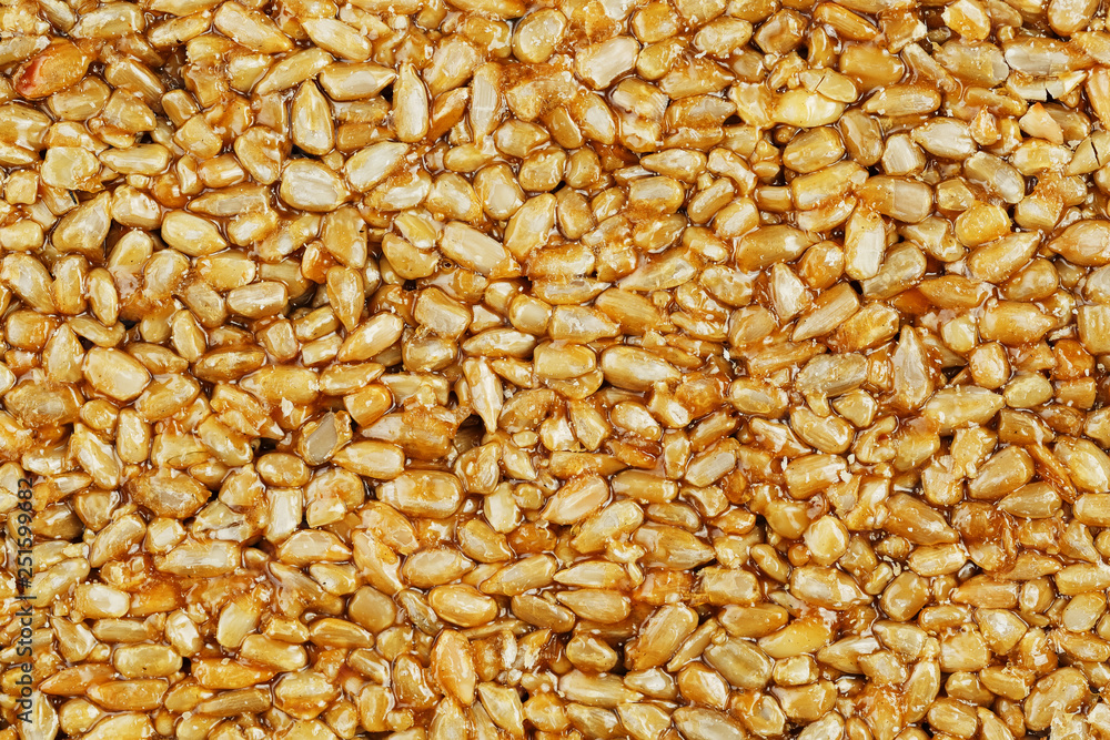 Kozinaki from golden, roasted sunflower seeds as a background, texture. Macro shooting, Kozinaki from golden, roasted sunflower seeds as a background, texture. Macro shooting,