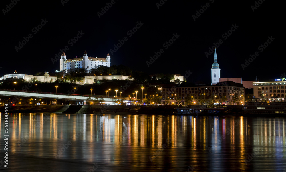 City at night, castle on the hill and river, Bratislava, Slovakia