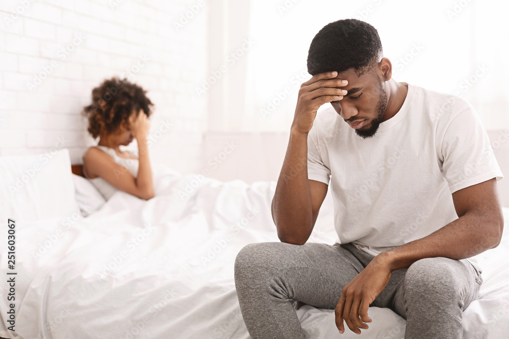 Young couple in bed having problems and crisis Young couple in bed having problems and crisis