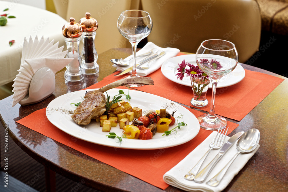 Fototapeta premium lamb leg with baked potatoes and herbs