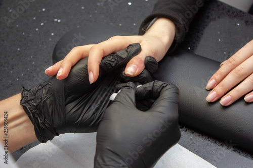 Manicure process. A woman works on the hands and nails of a woman. Close-up