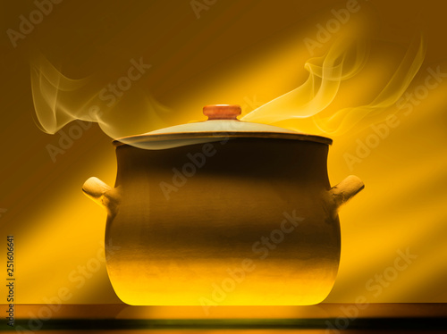 Obraz na plátně crock pot on mirror plate with steam, warm light