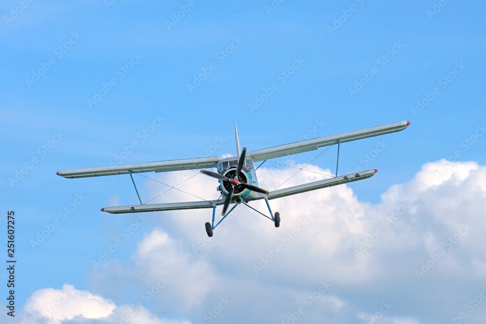 Old aeroplan on the background of blue sky with clouds Old aeroplan on the background of blue sky with clouds