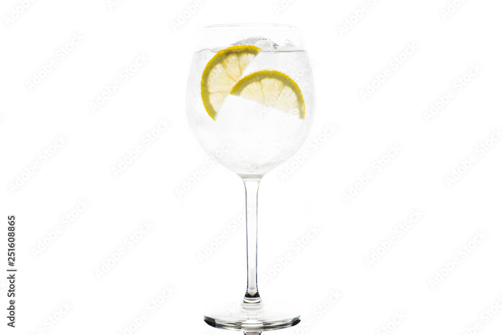 Gin based cocktail in wine glass isolated on white background. Selective focus. Shallow depth of field. Gin based cocktail in wine glass isolated on white background. Selective focus. Shallow depth of field.