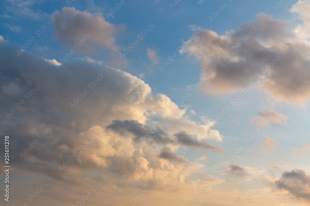 Obraz premium Beautiful cumulus clouds of unusual shape in the blue sky on a summer day