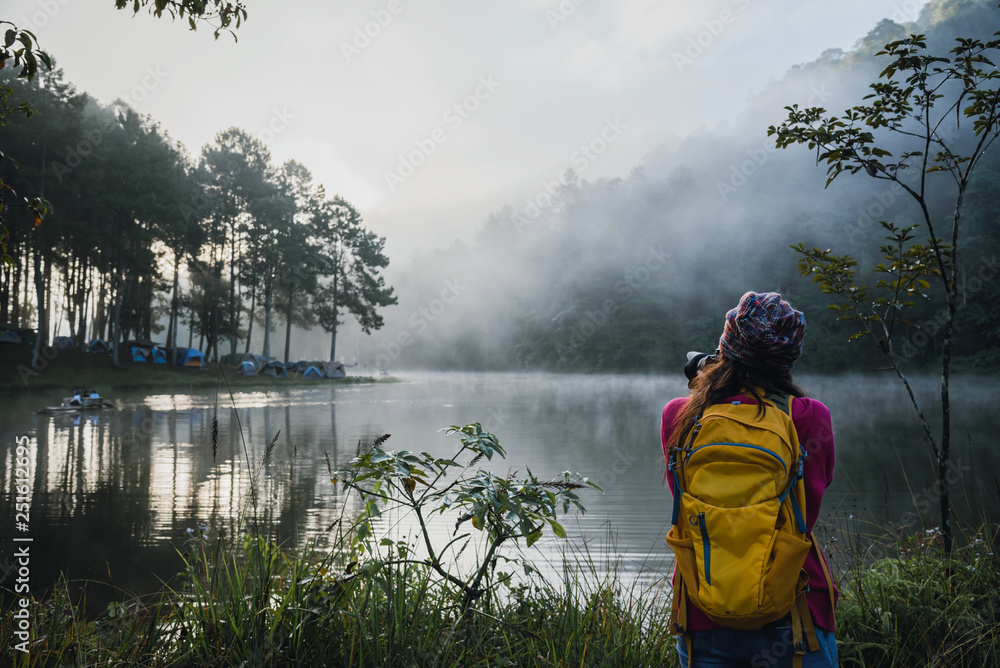 Young women travel to take pictures of beautiful natural forests, Pang Ung and pine forests in Mae Hong Son province, Thailand.