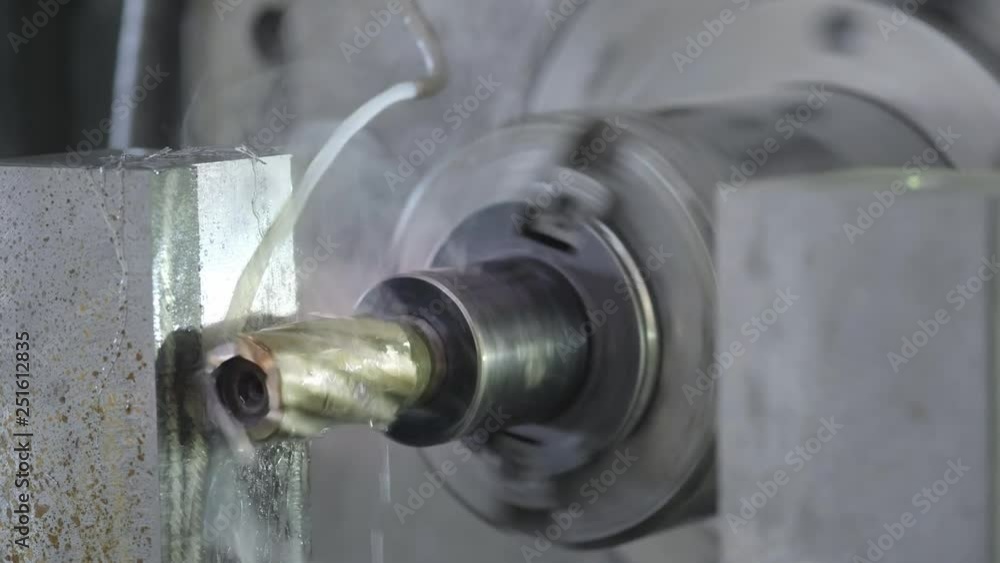 CNC Milling Machine Produces Metal Detail on Factory. Metalworking machine. Removes a layer of metal. CNC Milling Machine Produces Metal Detail on Factory. Metalworking machine. Removes a layer of metal.