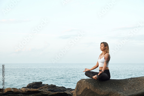 Woman Practicing Yoga in the Nature. Meditating Outdoors