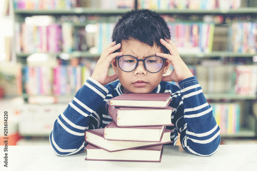 Schoolboy reading books for education and go to school in library . Education and Lifestyle Concept . Schoolboy reading books for education and go to school in library . Education and Lifestyle Concept .