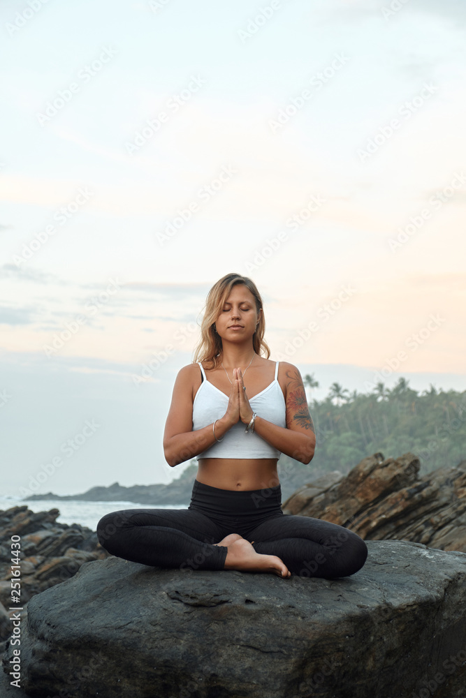 Woman Practicing Yoga in the Nature. Meditating Outdoors