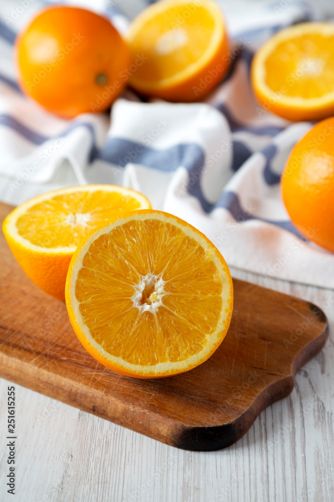 Halved and whole oranges, side view. Closeup. Selective focus. Halved and whole oranges, side view. Closeup. Selective focus.