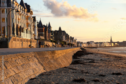 Beach in the evening sun and buildings along the seafront promenade in Saint Malo. Brittany, France photo