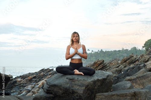 Woman Practicing Yoga in the Nature. Meditating Outdoors