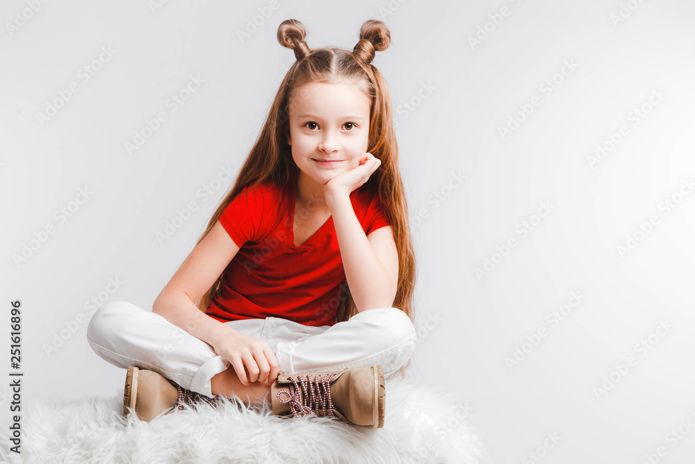 Emotional happy teen girl wearing a red t-shirt and horns shaped hair. Emotional happy teen girl wearing a red t-shirt and horns shaped hair.