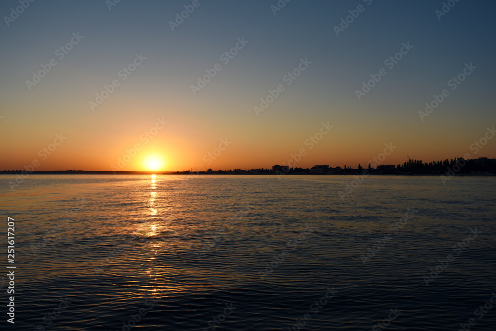 sunset over the calm black sea with seagulls sunset over the calm black sea with seagulls