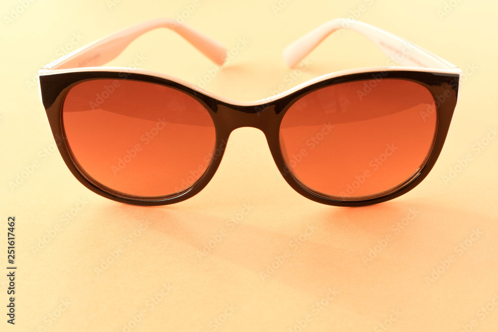 Sunglasses on orange background. The concept of summer. Sunglasses on orange background. The concept of summer.