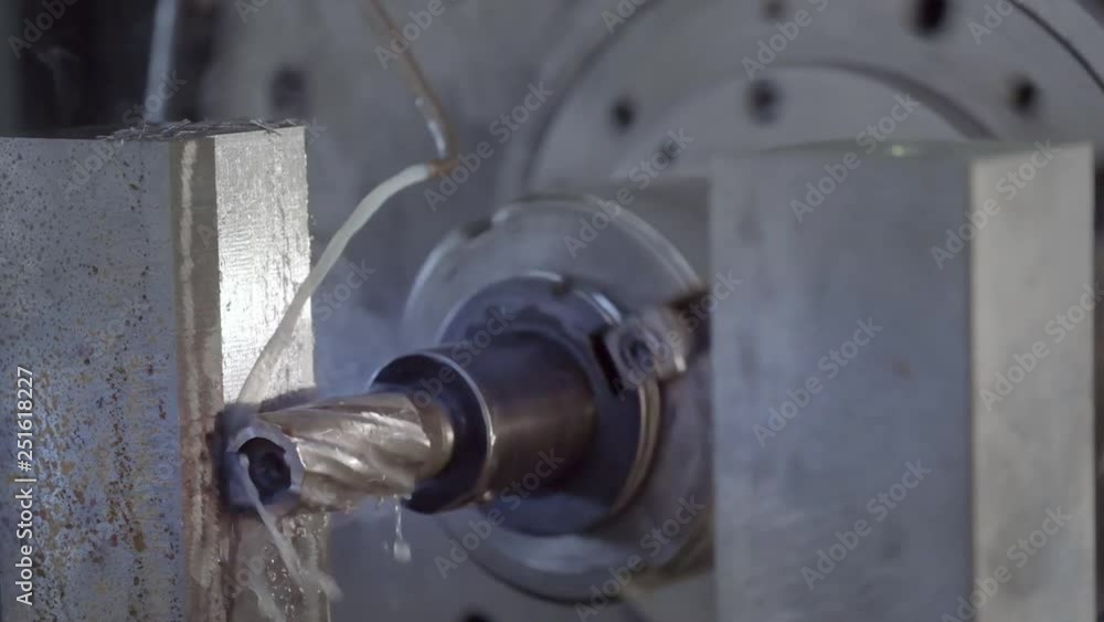 CNC Milling Machine Produces Metal Detail on Factory. Metalworking machine. Removes a layer of metal. CNC Milling Machine Produces Metal Detail on Factory. Metalworking machine. Removes a layer of metal.