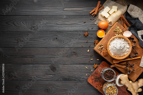 ingredients for baking ginger cookies on a rustic wooden background, view from above