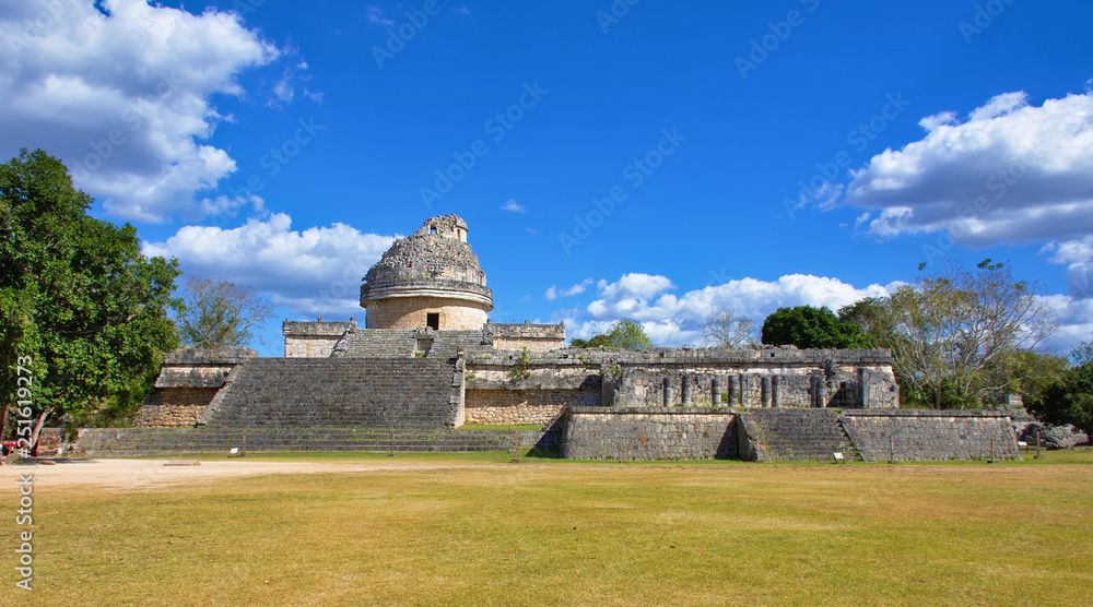 Sunny day with blue sky and white clouds. No people around. Mayan ruin. El Caracol in Yucatan, Mexico - Mar 2, 2018